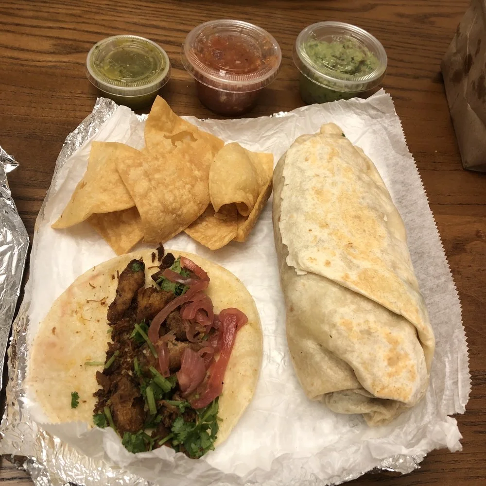 Al Pastor Tacos - Marinated pork tacos with pineapple, onion, and cilantro on corn tortillas.