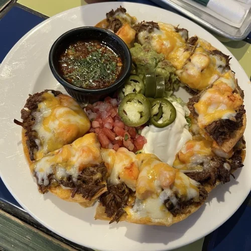 Birria & Shrimp Nachos - Crispy tortilla chips loaded with birria beef, juicy shrimp, melted cheese, jalapeños, and fresh toppings — perfect for sharing.
