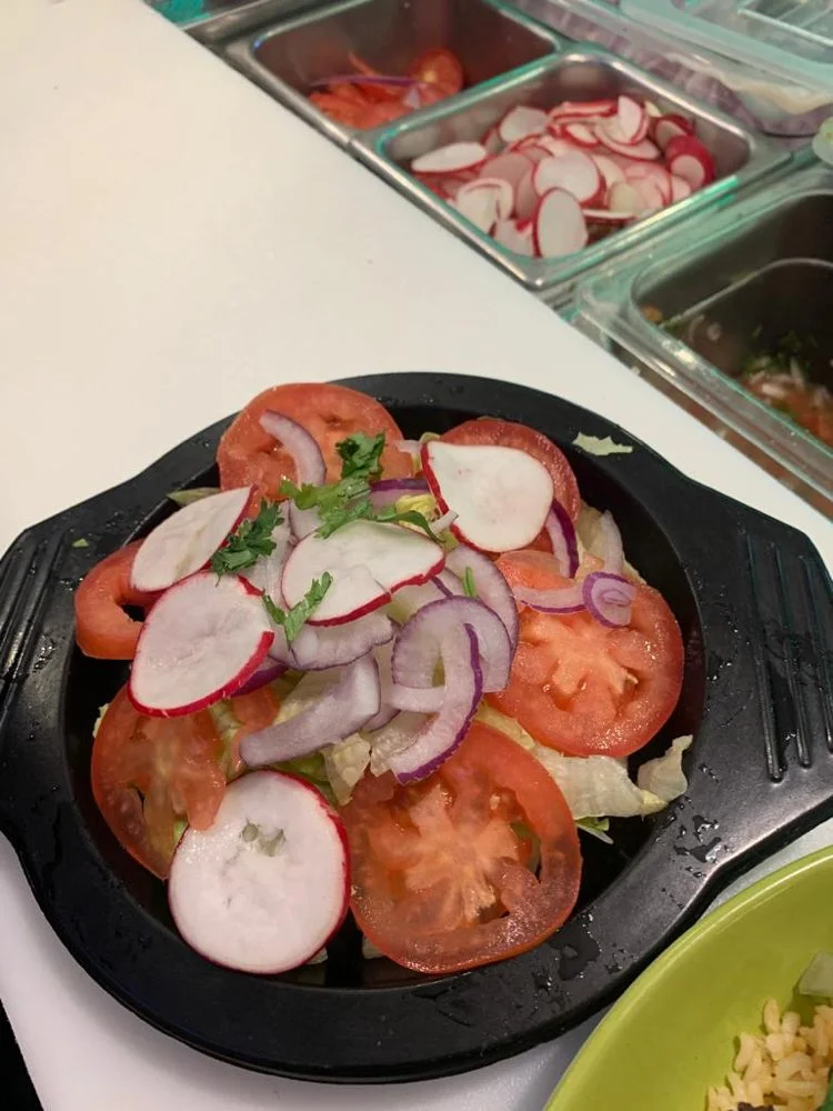 Cantina Steak - Grilled steak served with rice, beans, and fresh garnishes.