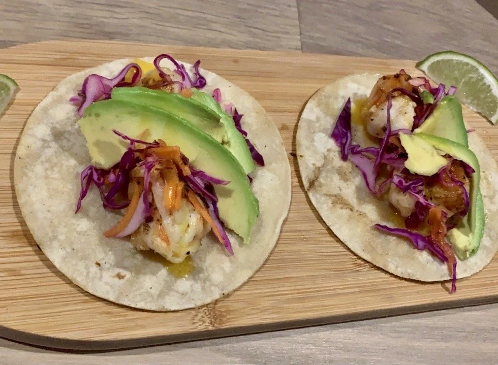 Grilled Shrimp Tacos - Juicy grilled shrimp tacos with fresh cabbage slaw, avocado, and lime crema.