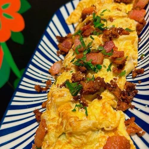 Mexican Omelette - Fluffy omelette filled with peppers, onions, cheese, and spiced Mexican chorizo.