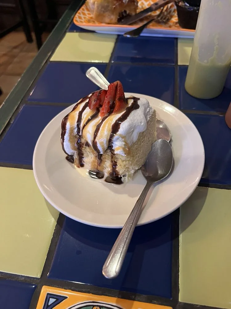 Tres Leches - Classic Mexican sponge cake soaked in three milks, topped with whipped cream.